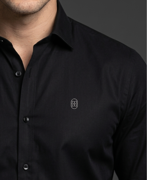 Close-up of the black formal shirt placket and monogram