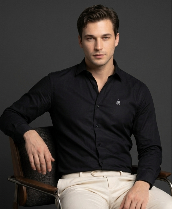Model seated in the black formal shirt
